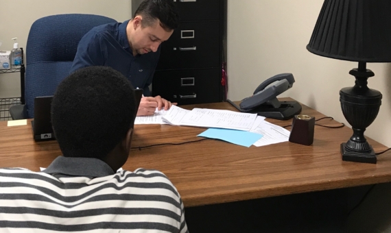 Photo of attorney speaking with client